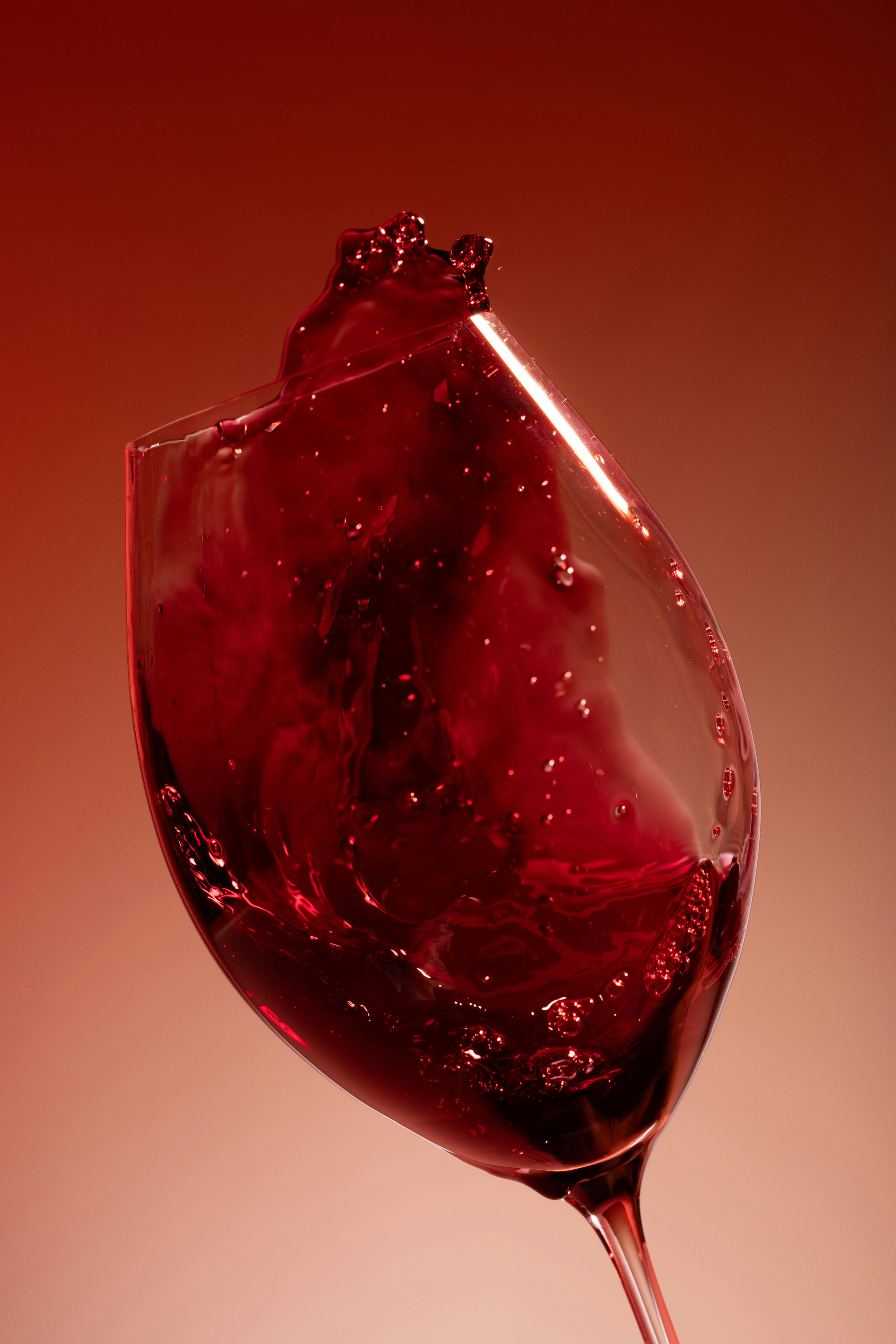 Red wine swishing vigorously inside a glass