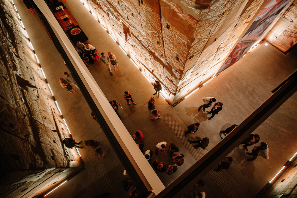 Birds eye view of people in the Void with large sandstone walls