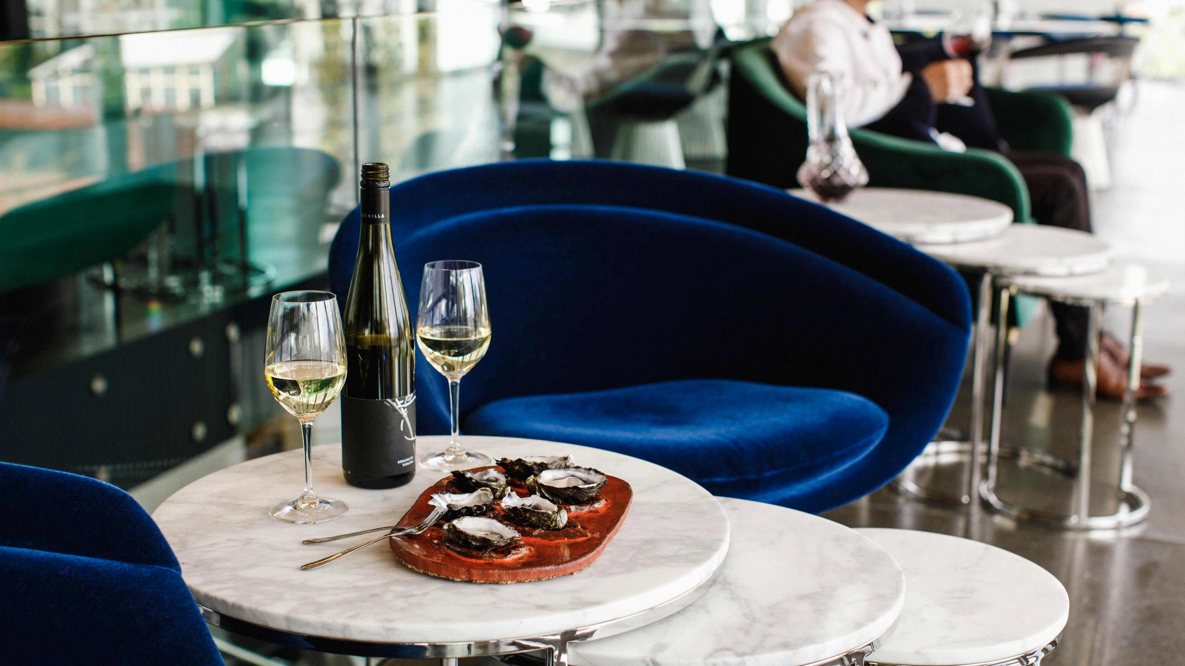 A plate of oysters served which a Moorilla riesling